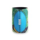 A colorful, neoprene can cooler featuring a stitched blue faux miniature football. The background includes green, yellow, and black abstract patterns, suggesting a tropical theme. The cooler is standing upright.
