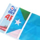 Close-up of a folded flag featuring a red airplane and text reading AIR FORCE and ROYAL AIR FORCE in blue and red. A blue area with a white star is visible. The flag appears on a white background.