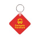 A red, diamond-shaped keychain features a yellow logo of a stylized chair and the text Fantastic Furniture beneath it. The keychain has a silver ring attached.