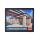 Mouse pad featuring an image of a modern brick house with a patio and outdoor seating. A blue sky is visible. Text reads, What can you build with Selkirk? along with contact details and website.