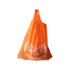 An orange reusable shopping bag with white text that reads Fonds Soziales Wien Stadt Wien, hanging against a plain white background.