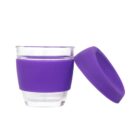 A glass cup with a purple silicone sleeve and matching purple lid, designed for portability. The sleeve covers the middle portion of the cup for easy grip, while the lid is placed upright beside the cup. The cup is empty and set against a white background.