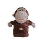 A plush monkey puppet with a brown body and gray face, arms, and ears. It has a big smile and is wearing a shirt with colorful handprints on it. The background is plain white.