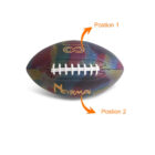 A colorful football with a honeycomb pattern and Normal written on it. Orange arrows point to Position 1 at the top of the ball and Position 2 at the bottom, indicating possible customization areas.