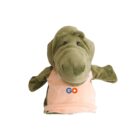 A green dinosaur puppet with a large snout, wearing a light orange shirt featuring a GO logo with a play button inside the letter O. The puppets arms are outstretched. The background is plain white.