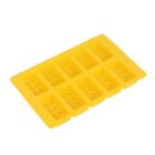 A yellow silicone ice cube tray designed to make ice shaped like rectangular blocks, resembling building bricks. It has multiple compartments, each with small circular indentations.
