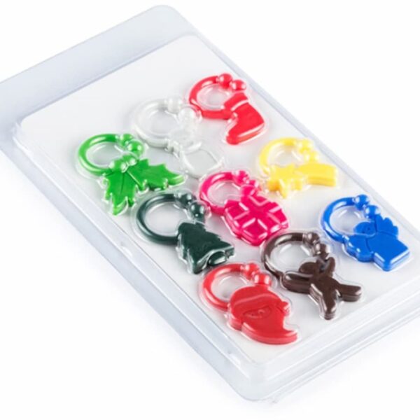 A plastic package containing colorful keychains shaped like holiday icons: Santa hats, Christmas trees, mittens, and reindeer in red, green, white, pink, yellow, brown, and blue.