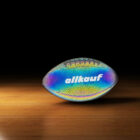 A football with a holographic design and the brand name allkauf on a wooden floor, set against a black background. The surface reflects rainbow colors.