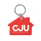 A red house-shaped keychain with the text CJU Medical Marketing printed on it in white. A silver metal key ring is attached at the top.