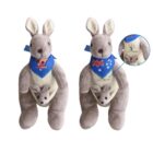 Two plush grey kangaroos with joeys in their pouches. They wear blue scarves: one with SUMMER and a koala design, the other with an Australian flag motif. Both have a blue ribbon around the neck. A magnified inset highlights the koala design.