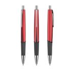 Three red and black retractable ballpoint pens are standing upright. They have shiny metallic clips and tips, with black rubber grips for comfortable handling.