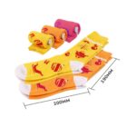 Colorful rolled and unrolled socks with playful patterns, including cats, oranges, and balloons, are displayed on a white background. The unrolled socks are yellow and orange, measuring 200mm and 190mm in length.