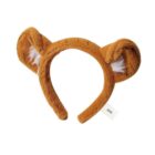 A brown plush headband shaped like lion ears with white inner detailing. A small white tag is attached to the band. The background is plain white.