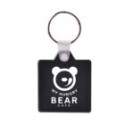Keychain with a square black tag featuring a white bear logo and the text MY HUNGRY BEAR CAFE in white. The bear design includes a curved line for a mouth and two circular ears. The tag is attached to a silver key ring.