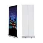 Two retractable banners stand side by side. The left banner features a colorful design with Tales of the Night text and an illustration of a city skyline. The right banner is blank, showing its white back. Both banners have metal bases.