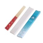 A packet of wooden sticks styled as a hand fan. The sticks are bundled and partially encased in a white sleeve. The packaging is light blue with floral patterns and the word Abanico written on it.