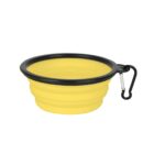 A collapsible yellow silicone pet bowl with a black rim and a carabiner clip attached. The bowl is partially extended, showing its expandable layers, designed for easy transport and outdoor use.