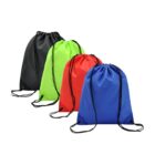 Four drawstring backpacks arranged in a row. The bags are colored black, neon green, red, and blue from left to right. Each bag has black drawstrings and eyelet reinforcements at the corners. The background is plain white.