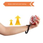 A hand using a wrist exercise ball with a strap. The wrist is raised, and two upward arrows appear, signifying improvement. A text at the top reads, Stress relief and wrist training.