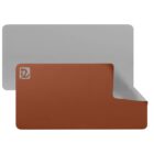 A large, reversible desk mat with one side in gray and the other in brown. The corner is flipped to show both colors. A logo is visible in the top left corner. The mat has rounded edges and a smooth surface.