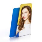 Two standing banners on a white background. The front banner features a young woman with long brown hair, wearing a white top, against a yellow backdrop. The rear banner is plain blue.