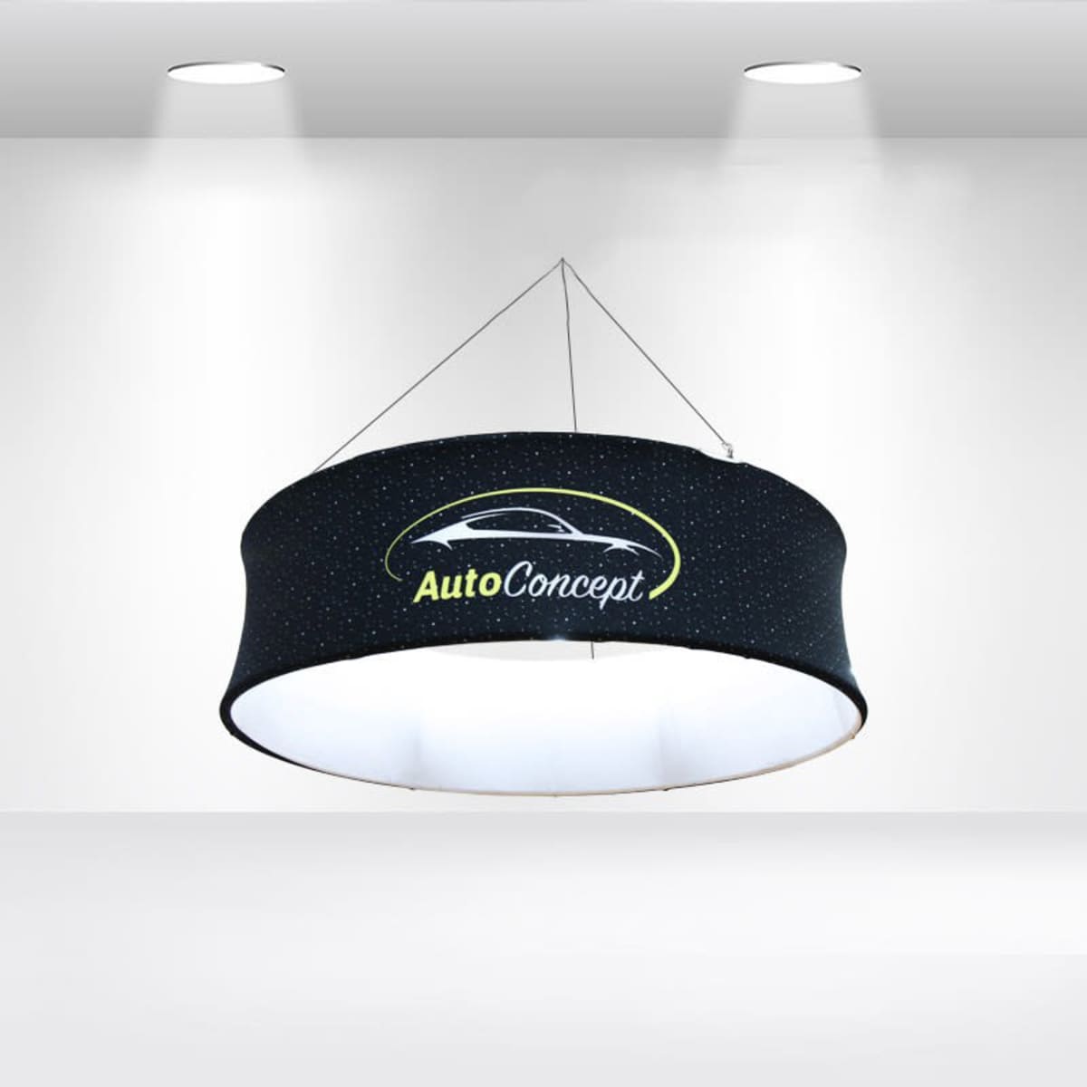 A circular, hanging sign with the logo AutoConcept featuring a stylized car design. It is suspended from a ceiling and illuminated by spotlights in a minimalistic white room.