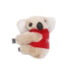 A small plush koala with a white and beige body is wearing a red shirt. The shirt has white text partially visible, reading I W. The koala is positioned on a white background.