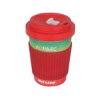 Red reusable travel mug with a textured grip and sip lid, featuring a green and yellow section with white Cyrillic text.
