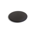 A round, flat black disc placed on a white background, casting a subtle shadow to the left.