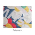 Close-up of a colorful debossed pattern on a textured surface, featuring overlapping shapes and raised letters. The word Debossing is written below the image.