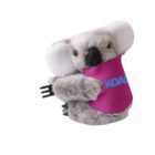 A plush koala toy with a pink bib that says KOAL in blue letters. The koala is gray with white ears and a black nose, holding a black comb in its right arm. The background is white.