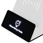 A black charging stand with the text Advertising Media and a light bulb icon is shown. The stand features a wireless charging symbol on its translucent surface.