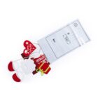 A decorative gift tag shaped like Santa faces emerges from a white envelope. The tag features red and white holiday designs, including Santa hats and Christmas greetings. The envelope has lines for addresses and a stamp outline.