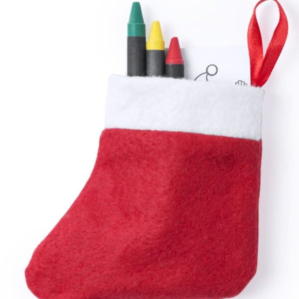 A small red and white felt stocking holds three crayons—green, yellow, and red—and a piece of paper with a doodle. The stocking has a red loop for hanging.