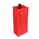 Red gift bag with rope handles, holding a bottle with a dark cap partially visible at the top. The bag is standing upright against a white background.
