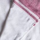 Close-up of a white fabric with a red and white striped border in the corner. The fabric appears textured, and the red stripes provide a contrasting accent to the otherwise plain white material.