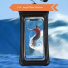A smartphone in a waterproof case displays an image of a person surfing on a wave. The case is black with a clear window, and a text overlay reads Full Length Clear Window.