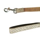 A close-up image of a dog leash featuring a metal clasp on one end and a loop handle on the other. The strap is brown, and the handle has a decorative pattern of circular shapes. The background is white.