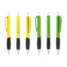 Six ballpoint pens are shown in a row against a white background. Three pens have yellow bodies with black grips, and three have green bodies with black grips. Each pen has a silver clicker and pocket clip.