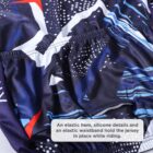 Close-up of a colorful cycling jersey featuring a blue, white, and red abstract pattern. A caption highlighted on the image says, An elastic hem, silicone details and an elastic waistband hold the jersey in place while riding.