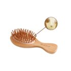 A bamboo hairbrush with wooden bristles, featuring a close-up inset showing details of a bristle. The handle is engraved with the words think food.