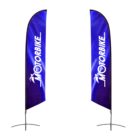 Two tall, blue, teardrop-shaped flags with MOTORBIKE written in white. Each flag features a stylized motorcycle icon above the text. The flags have curved tops and are supported by metal bases.
