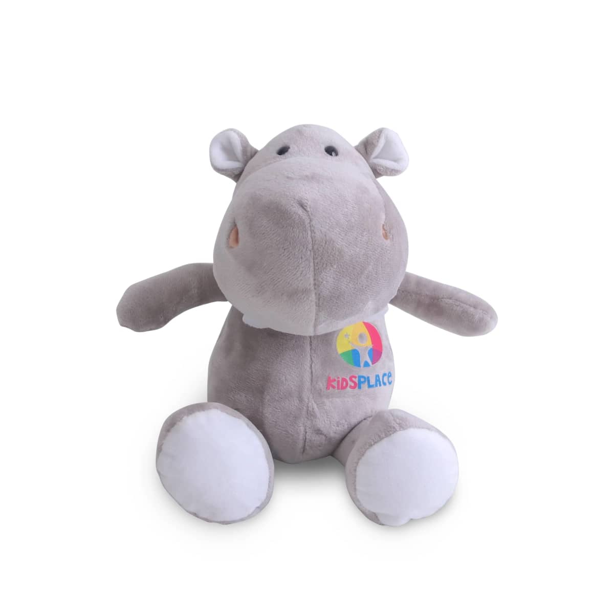 A plush toy shaped like a hippopotamus, with light gray fur and white accents on its feet and ears. It features a colorful kidSPACE logo on its belly. The hippo has a friendly expression, with small, round eyes and a subtle smile.