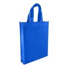 A bright blue, reusable fabric tote bag with two handles. The bag is standing upright, showcasing its rectangular shape and simple design. The background is plain white.