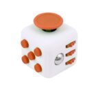 A white fidget cube with orange accents, featuring buttons, switches, and a joystick on different sides, designed to provide tactile sensory stimulation.