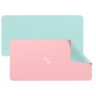 A minimalist desk mat with a light blue surface. A pink underside is partially visible as if flipped over. In the center of the visible side, theres a small logo with the letters HM.