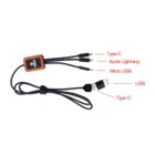 A black multi-charging cable with braided texture, featuring three outputs: USB Type-C, Apple Lightning, and Micro USB. It has labeled connectors and a USB input, alongside a reddish-brown rectangular adapter with a button.