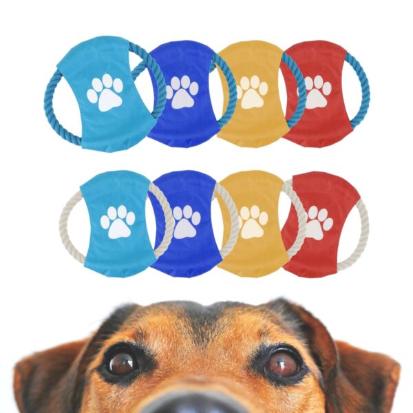A dogs face peeks at the bottom of the image, looking up at colorful chew toys above. The toys have white paw prints and are in blue, yellow, and red colors, arranged in two rows of four.