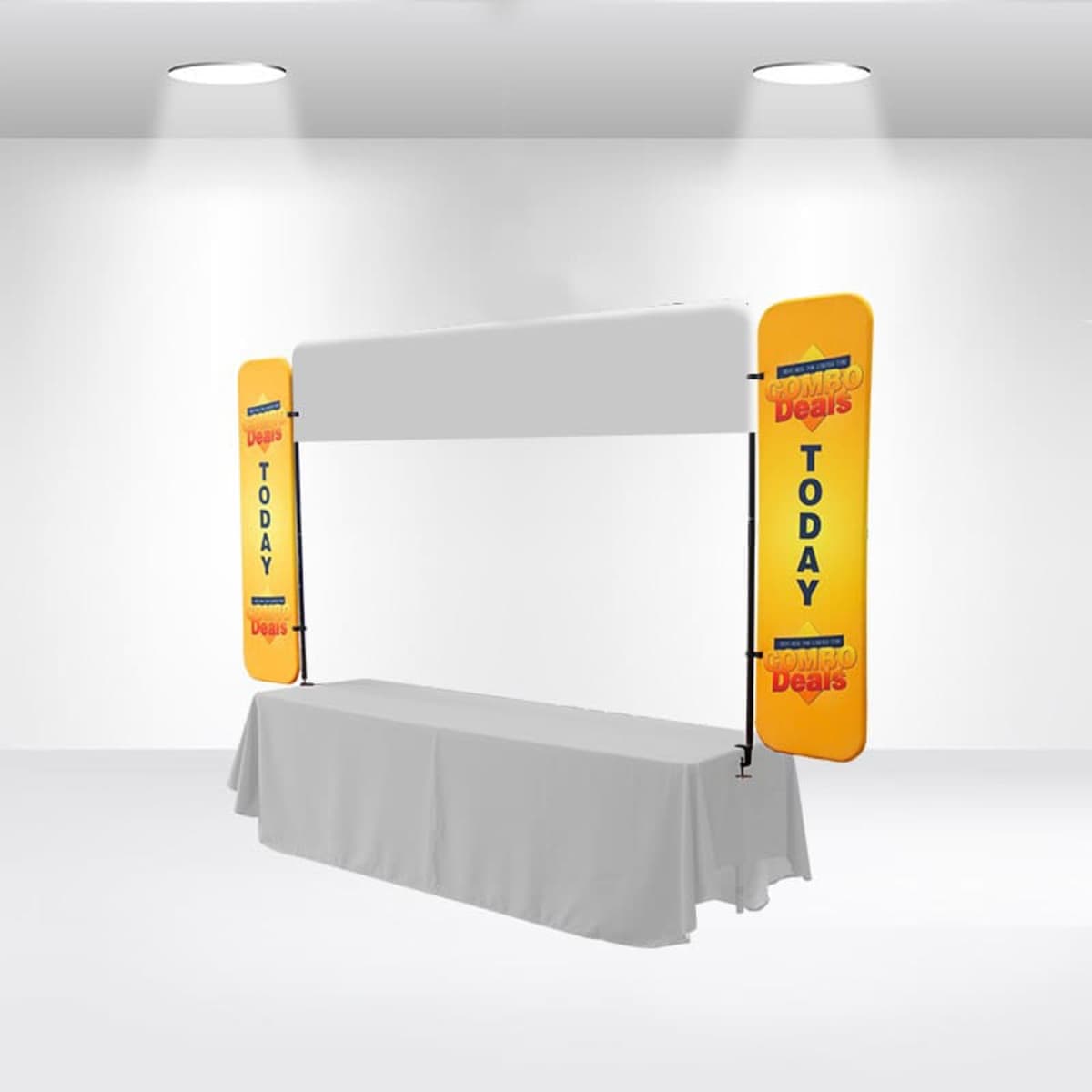 A white exhibition booth with a long table covered in a white cloth. Two vertical yellow banners on each side display COMBO Deals and TODAY in bold letters. The setup is in a white room with spotlights above.