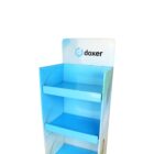 A three-tier, light blue display stand with the word doxer and a logo on the top panel. The stand is empty and set against a plain white background.